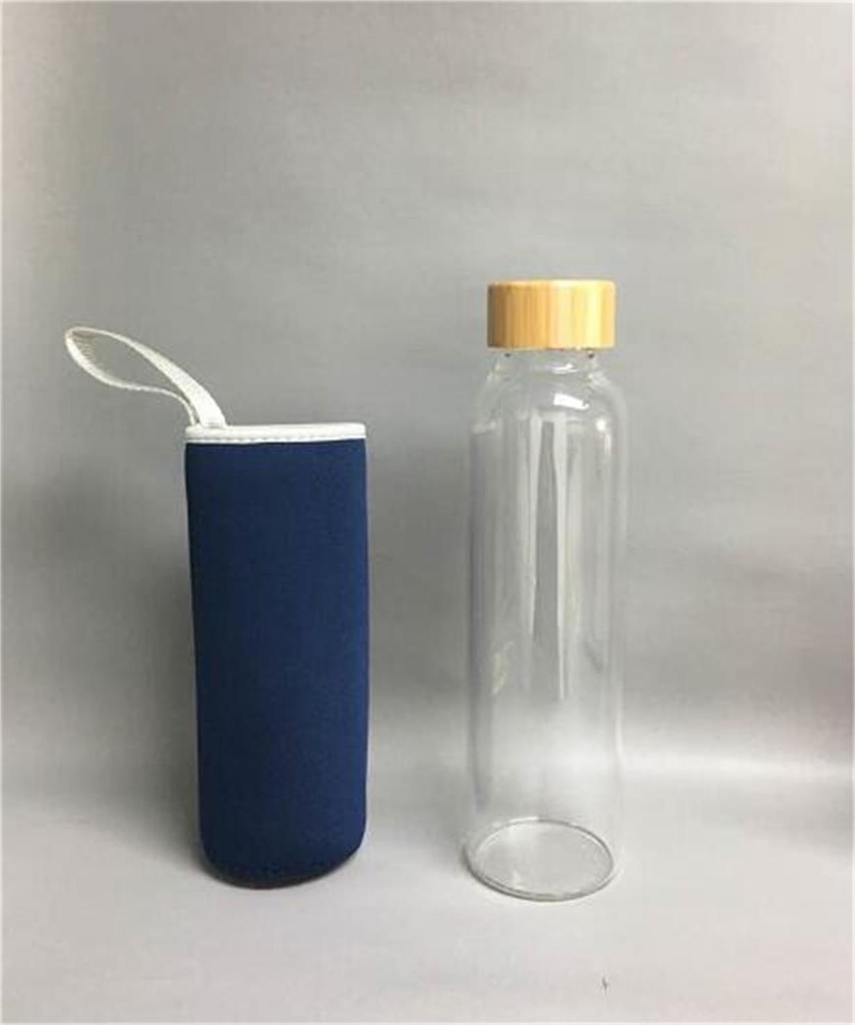 Glass water bottle with bamboo lid and sleeve