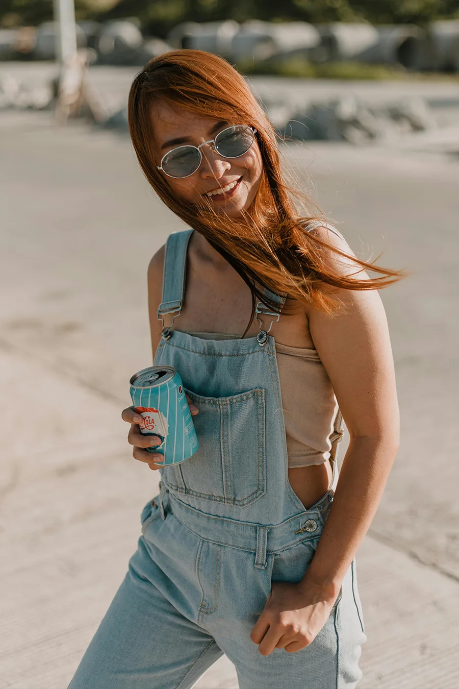 Women's denim jumpsuit with stand-up collar, front buttons, and belt